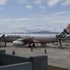 Passenger held at Australian airport after exiting plane via emergency door