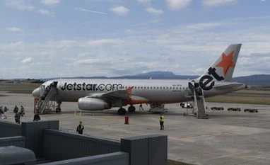 Passenger held at Australian airport after exiting plane via emergency door Jetstar flight