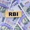 Rupee holds above lifetime low, supported by likely RBI intervention