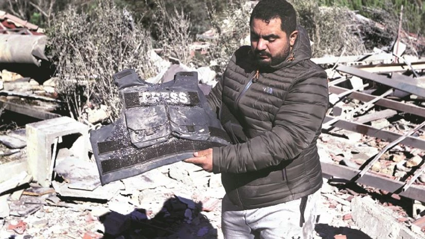 A journalist at the site where an Israeli airstrike hit a compound housing three journalists, in Hasbaya village, southeast Lebanon, on Friday. (PHOTO: AP/PTI) A journalist at the site where an Israeli airstrike hit a compound housing three journalists, in Hasbaya village, southeast Lebanon, on Friday. (PHOTO: AP/PTI)