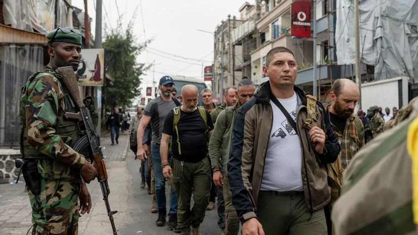 Democratic Republic of Congo, DRC, DR Congo, M23, M23 rebel, Congo A member of the M23 rebel group supervises the exit of mercenary troops in the streets of Goma amid conflict between them and FARDC, in Goma, eastern Democratic Republic of the Congo, January 29, 2025 | Photo by Arlette Bashizi on Reuters