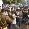 Patna: A police personnel checks the admit card of a student among others who wait to appear for the Bihar Board class 10th exam, in Patna | Photo: PTI