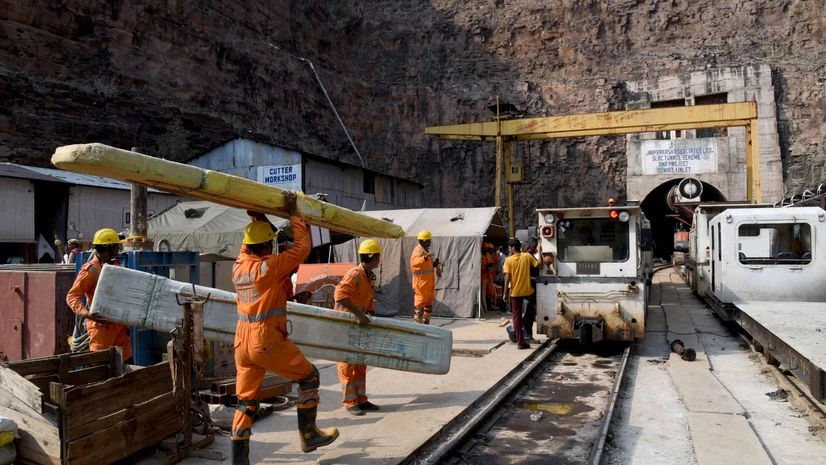 Telangana Tunnel Collapse, SLBC, Nagarkurnool Members of National Disaster Response Force (NDRF) team carry their equipment during a rescue operation outside the Srisailam Left Bank Canal (SLBC) tunnel after a portion of the tunnel collapsed, in Nagarkurnool district in the southern state of Tel