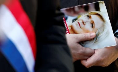 Marine Le Pen A local elected official from the French far-right Rassemblement National (National Rally - RN) political party, distributes leaflets in support of French far-right leader Marine Le Pen at a market, a day after she was found guilty of embezzlement of