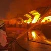 Firefighters and fire tendors deployed at the site trying get control of the fire in warehouse. | Photo: PTI