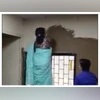 The principal of Laxmibai College is seen applying cow dung on the walls