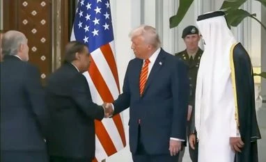 Donald Trump, Mukesh Ambani US President Donald Trump shakes hands with Reliance Industries Chairman Mukesh Ambani