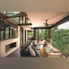 A glass treehouse in New Delhi, inspired by German-American architect Mies van der Rohe's Edith Farnsworth House in Illinois A glass treehouse in New Delhi, inspired by German-American architect Mies van der Rohe’s Edith Farnsworth House in Illinois
