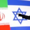 A 3D printed miniature model of U.S. President Donald Trump, Israel and Iran flags are seen in this illustration