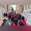 Graduating Harvard University students walk through Harvard Square in Cambridge, Massachusetts