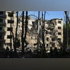 Firefighters work in a destroyed apartment building after a Russian attack in Kyiv