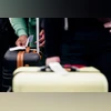 A traveler puts a tag on their luggage.