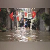 People wade through a flooded alley caused by Typhoon Kajiki in Hanoi, Vietnam, Tuesday, Aug. 26, 2025 | AP/PTI