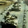 Indian soldiers atop T-72 tanks, India's main battle tanks, cross a bridge as they take part in an exercise to demonstrate firepower in Mahajan Field Firing Ranges in the Indian desert state of Rajasthan March 1, 2004 (Photo: Reuters)