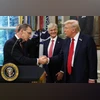 Donald Trump shakes hands with Albert Bourla in the Oval Office of the White House on Sept 30