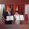 Donald Trump and Sanae Takaichi with their signed documents at the ceremony in Tokyo