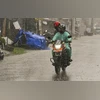Nadia: A motorcyclist rides through a road amid rain triggered by Cyclone Montha, in Nadia, West Bengal, Wednesday, Oct. 29, 2025. (PTI Photo)