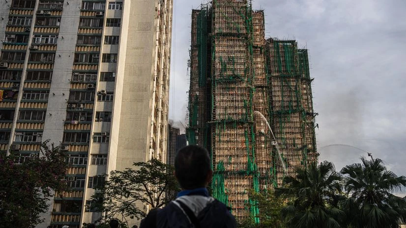 Hong Kong fire Firefighters hose down a smouldering residential building at the Wang Fuk Court in the Tai Po district of Hong Kong, China, on Thursday, Nov. 27, 2025.