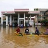 People use a boat to navigate a flooded street in Colombo, Sri Lanka, Saturday, Nov. 29, 2025. (AP Photo/Eranga Jayawardena)