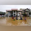 People use a boat to navigate a flooded street in Colombo, Sri Lanka, Saturday, Nov. 29, 2025. (AP Photo/Eranga Jayawardena)