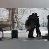 Students hug on the campus at Brown University following a mass shooting in Providence, Rhode Island on Dec. 14