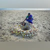 A woman lights a candle as she offers prayer for the victims of the 2004 Indian Ocean Tsunami on the 21st anniversary of the disaster, at Pattinapakkam beach in Chennai, India December 26, 2025 | REUTERS A woman lights a candle as she offers prayer for the victims of the 2004 Indian Ocean Tsunami on the 21st anniversary of the disaster, at Pattinapakkam beach in Chennai, India December 26, 2025 | REUTERS