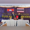Cambodia's Defence Minister Tea Seiha and Thailand's Defence Minister Natthaphon Narkphanit pose with documents during a special General Border Committee (GBC) meeting at a border checkpoint | REUTERS Cambodia's Defence Minister Tea Seiha and Thailand's Defence Minister Natthaphon Narkphanit pose with documents during a special General Border Committee (GBC) meeting at a border checkpoint | REUTERS