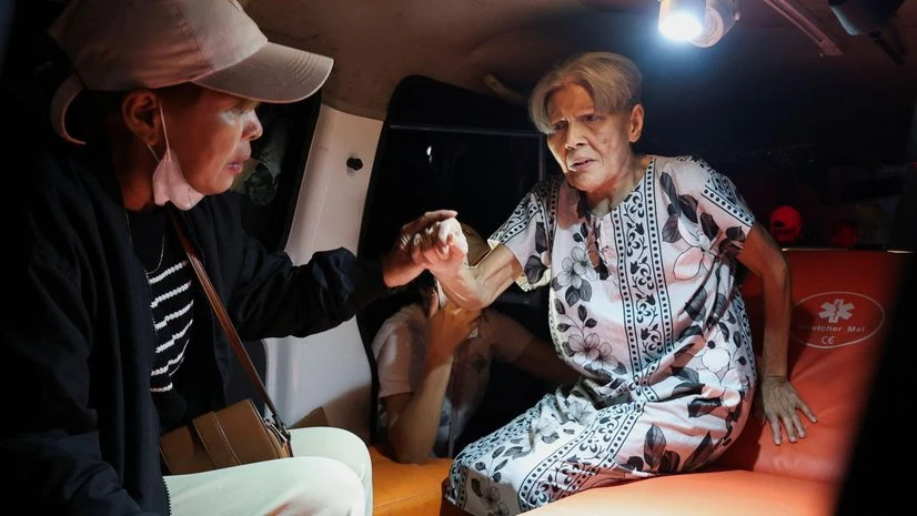 Local people rescue an elderly woman during a fire at Werdha Damai retirement home in Manado, North Sulawesi Province, Indonesia, December 28, 2025 | REUTERS Local people rescue an elderly woman during a fire at Werdha Damai retirement home in Manado, North Sulawesi Province, Indonesia, December 28, 2025 | REUTERS