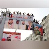 Supporters of Yemen's southern separatists stand on a billboard during a rally to show support to the United Arab Emirates. (Photo: Reuters)