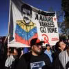 Demonstrators hold a banner depicting US-deposed Venezuelan President Nicolas Maduro that reads "Freedom to Maduro, Yankees go home" | Reuters