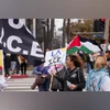 A woman holds a sign reading “LA melts ICE” alongside other demonstrators carrying a Palestinian flag during a protest against US President Donald Trump's policies on the one-year mark into his second term in office in Los Angeles. New York City Mayo