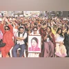 Facing democracy test, Bangladesh at a crossroads ahead of elections A BNP supporter holds a photo of former PM Khaleda Zia at an election campaign rally in Dhaka | Photo: Reuters