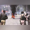 Shiite Muslims throw stones toward paramilitary soldiers and police officers in a protest to condemn the killing of Khamenei near the US Consulate in Karachi on Sunday | Photo: AP/PTI Shiite Muslims throw stones toward paramilitary soldiers and police officers in a protest to condemn the killing of Khamenei near the US Consulate in Karachi on Sunday | Photo: AP/PTI