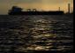 US Navy fires at Iranian-flagged vessel in Gulf of Oman as part of blockade