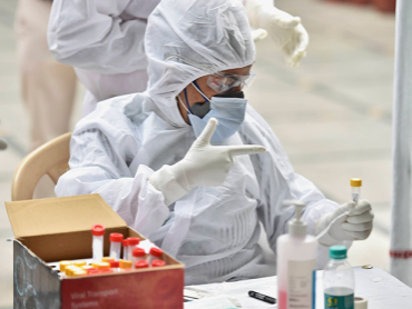 Health workers collect swab samples from people for COVID -19 tests,in New Delhi. Photo: PTI
