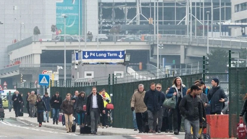 People walk away from Brussels airport after explosions rocked the facility in Brussels, Belgium People walk away from Brussels airport after explosions rocked the facility in Brussels, Belgium