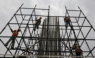 Industrial output rises 1.2% in May Workers erect scaffolding to build a pillar at the site of the metro railway flyover under construction in Ahmedabad (Pic: Reuters)