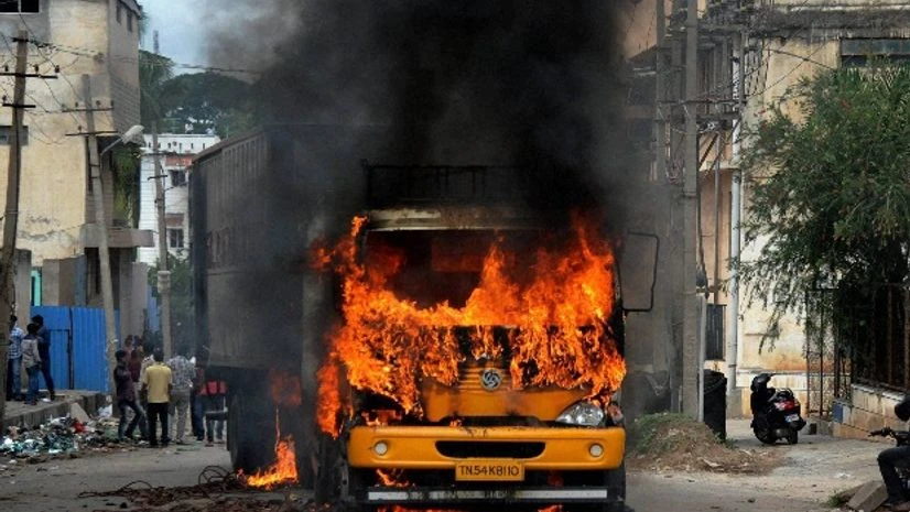 A vehicle from Tamil Nadu in flames after it was torched by pro-Kannada activists during a protest over Cauvery water row, in Bengaluru A vehicle from Tamil Nadu in flames after it was torched by pro-Kannada activists during a protest over Cauvery water row, in Bengaluru