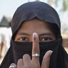 A muslim women displays the indelible ink mark on her finger after casting her vote in the polling booth for Zilla Parishad Panchayat Samiti election at Saidapur Village in Karad,Maharashtra on Tuesday.