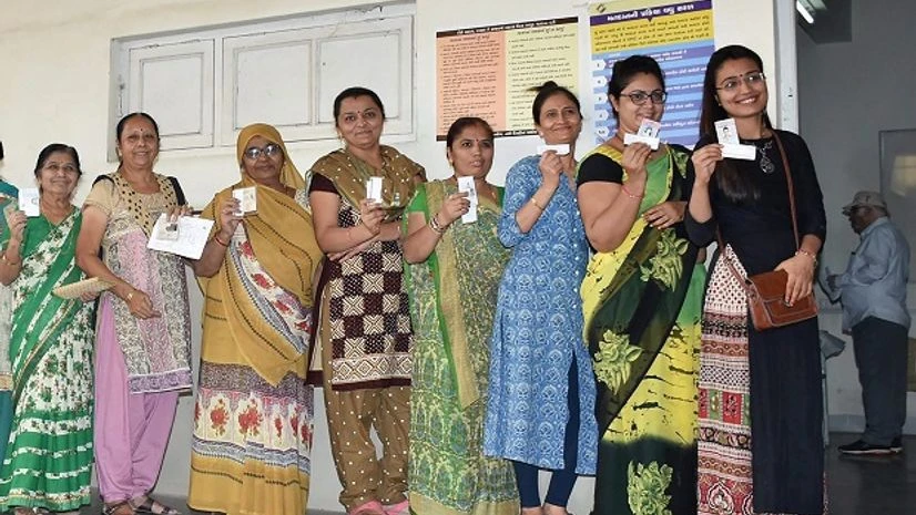 women line up to cast their ballot in Gujarat women line up to cast their ballot in Gujarat