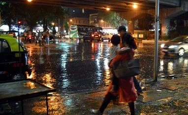 Monsoon hits Maharashtra, Odisha; IMD forecasts 'heavy rains' in Mumbai A woman walks during rains in Mumbai on Saturday, Jun 02, 2018