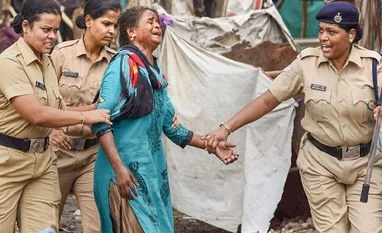 A slum dweller taken away by police personnel during a demolition drive of illegal slums on CIDCO plot, in Navi Mumbai on Tuesday, June 05, 2018. A slum dweller taken away by police personnel during a demolition drive of illegal slums on CIDCO plot, in Navi Mumbai on Tuesday, June 05, 2018.