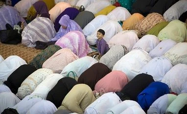 BJP's Eid surprise: 3.2 mn Muslim families to receive 'Saugat-e-Modi' kits A Muslim boy waits for his parents to offer prayers during the first day of Eid al-Fitr, which marks the end of the holy fasting month of Ramadan in Kuala Lumpur, Malaysia. Photo: PTI