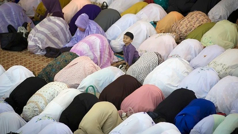 A Muslim boy waits for his parents to offer prayers during the first day of Eid al-Fitr, which marks the end of the holy fasting month of Ramadan in Kuala Lumpur, Malaysia. Photo: PTI Eid