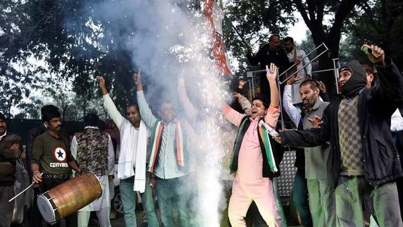 Congress Party worker celebrate as initial trends show the party leading in the states Assembly elections, at Congress office, in New Delhi Congress Party worker celebrate as initial trends show the party leading in the states Assembly elections, at Congress office, in New Delhi