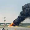 smoke rises from fire on a plane at Moscow's Sheremetyevo airport