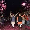 Bhartiya Janata Party workers welcome Prime Minister Narendra Modi as he, along with BJP President Amit Shah, arrives at the party headquarters to celebrate the party's victory in the 2019 Lok Sabha elections
