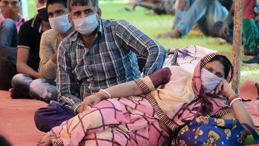 Coronavirus, lockdown 5.0, Unlock 1.0 Migrants wait to board the bus to their native place during the nationwide lockdown 5 imposed in the wake COVID 19 Coronavirus pandemic, at Tau Devi Lal Stadium in Gurugram.