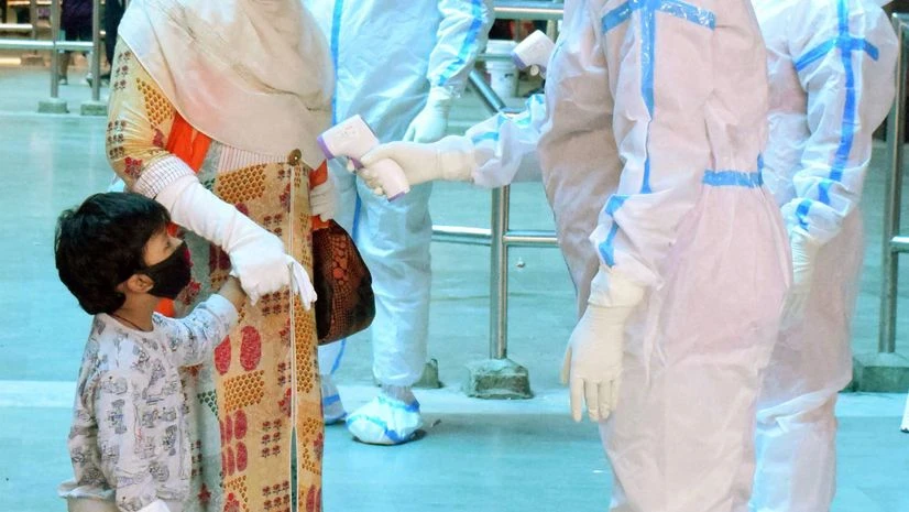 Health workers Health workers wear PPE kit conduct thermal screening on passengers as they arrive at Howrah Station, in Kolkata on Thursday.
