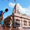 Workers cleaning disinfectant at Maa Badi Khermai temple ahead of its re-opening, during the ongoing COVID-19 lockdown, in Jabalpur on Saturday.